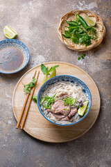 Top view of pho bo vietnamese rice noodle soup with herbs and sauce - 438573530