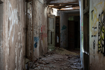 Old abandoned building in ruins, it is a dangerous site with graffiti