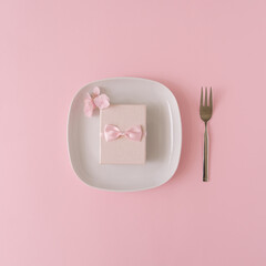 Romantic composition made of gift box served on plate with pink details.Romantic concept.Flat lay.