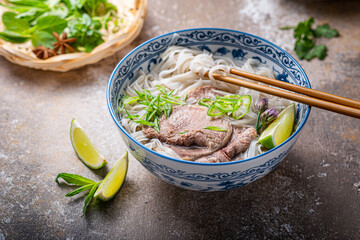 Rice noodles soup with beef and herbs or vietnamese pho bo, close view