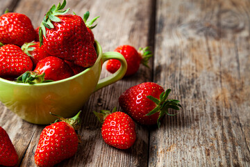 Ripe strawberries in a green cup