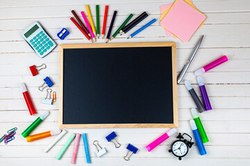 Various school supplies on a wooden table.