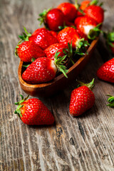 Ripe strawberries in a wooden bowl
