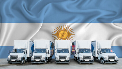 Argentina flag in the background. Five new white trucks are parked in the parking lot. Truck,...