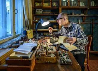 Radio amateur repairing an old radio receiver