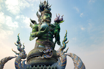 Low angle view of a giant Hindu sculpture in the famous Wat Rong Suea Ten or Blue Temple in Chiang...