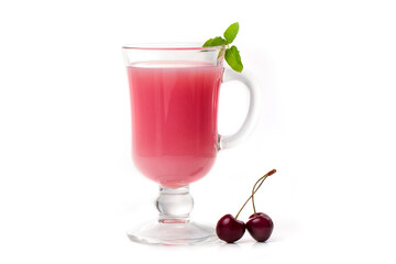 Milk cocktail with cherry in a clear glass and berries on a light background.