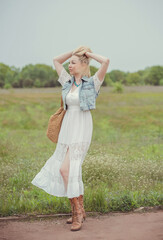 Fototapeta na wymiar Boho style, Portrait of fashionable middle age woman countryside 