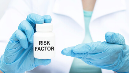 Risk Factor inscription on a can of medicine in the hands of a doctor in blue styres, close-up