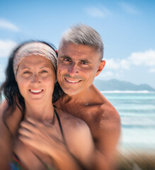 Beautiful couple in 40s relaxing along La Digue rocks, Seychelle