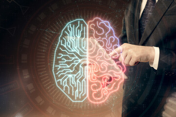 Double exposure of man's hand holding and using a digital device and brain hologram drawing. Data...
