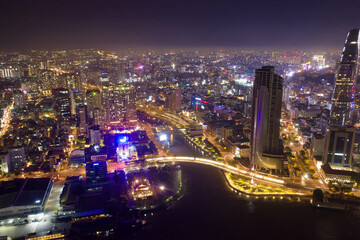 Obraz na płótnie Canvas Ho Chi Minh City skyline and the Saigon River. Amazing colorful night view of skyscraper and other modern buildings at downtown. Ho Chi Minh City is a popular tourist destination of Vietnam.