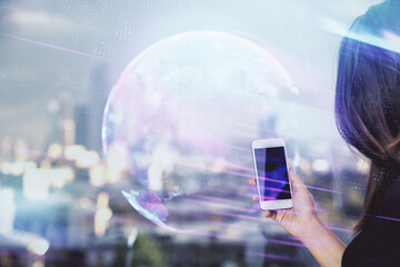 Double exposure of tech icon hologram and woman holding and using a mobile device. Technology...
