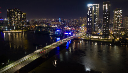 Ho Chi Minh City skyline and the Saigon River. Amazing colorful night view of skyscraper and other modern buildings at downtown. Ho Chi Minh City is a popular tourist destination of Vietnam.