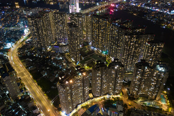 Ho Chi Minh City skyline and the Saigon River. Amazing colorful night view of skyscraper and other modern buildings at downtown. Ho Chi Minh City is a popular tourist destination of Vietnam.