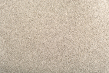 Fototapeta na wymiar the texture of a smooth beige sandy surface