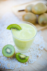 
Healthy fresh kiwi smoothie in glass on a wooden background