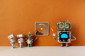 A robot tour guide with a pointer tells the story of the emergence of an electric light bulb. A group of young robots are observing a photo artwork.