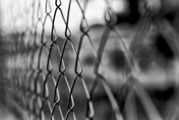 Wire mesh close-up and sky background, black and white