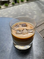 ice latte in a glass with ice outdoor