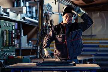 Portrait of a smiling welder posing in the factory