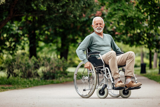 Disabled mature man, taking his picture happily.