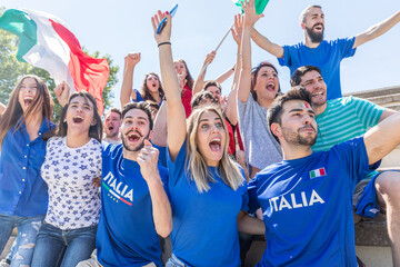 Italian supporters celebrating at stadium with flags