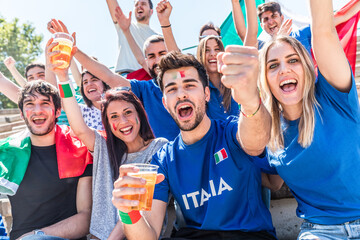 Italian supporters celebrating at stadium with flags