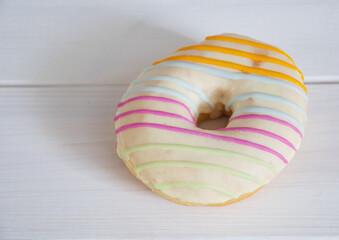 multicolored donut covered with glaze close-up