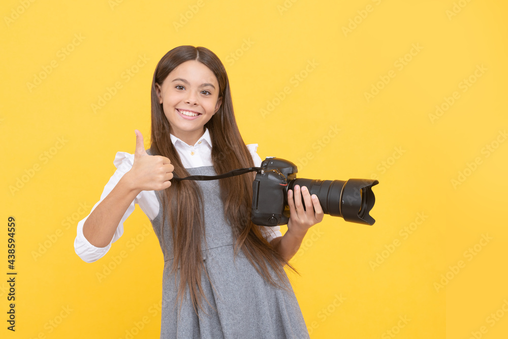 Wall mural the best. childhood. teen girl taking photo. kid use digital camera. happy child photographing.