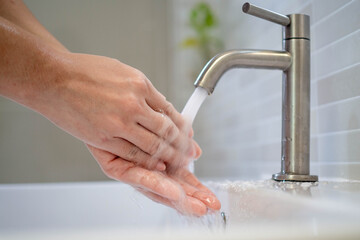 Women are washing hands with clean water. Wash your hands to keep them clean and prevent the spread of viral..