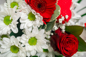 Flower bouquet close-up. A bouquet of flowers is collected by a florist from different flowers, a flower arrangement. Photo with a small depth of field, defocus. 