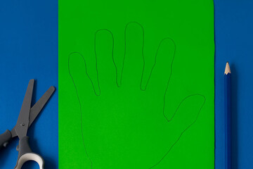 Step 2. Step-by-step instructions on how to make a funny hand-shaped monster out of colored paper. DIY concept. Children's art project. Halloween decoration