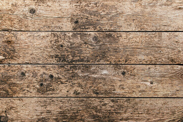 Brown rustic aged wooden plank rough background or  dry textured wood panel weathered backdrop  with stains and cracks.