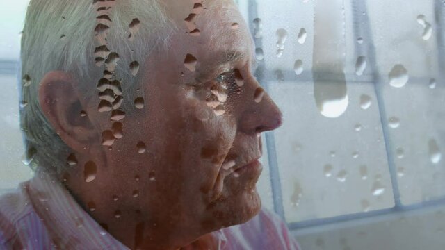 Animation of water drops on glass over worried senior man