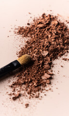 broken eye shadow scattered across the smooth pink surface. Texture background, advertising the structure of cosmetics. macro, copyspace