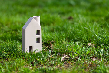 Vacation home. Toy house on the grass. Buying rural real estate.