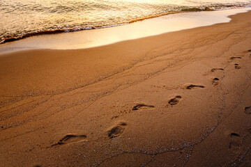 step Footprints on sand beach at morning
