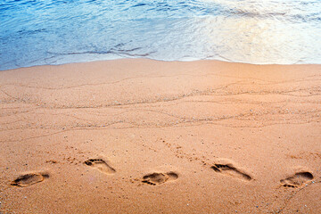 Footprints on sand beach at morning