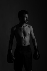 Fototapeta na wymiar Black and white portrait of a boxer in shadows