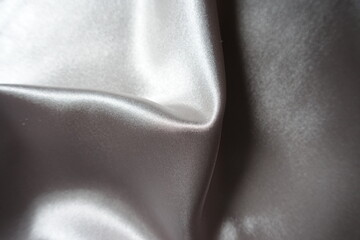 Folded glossy gray unprinted polyester satin fabric