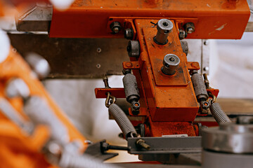 selective focus photo of fragment of print screening apparatus. serigraphy production. printing images on t-shirts by silkscreen method in a design studio