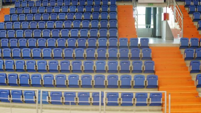 Drone Shot Inside An Empty  Sports Hall. Empty blue seats