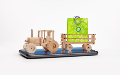 Wooden tractor with trailer, carries a paper bag for shopping and gifts. Sales concept. Concept of savings and discounts..Online sales concept. Goods on sale.