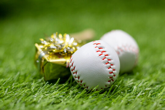 Baseball for Christmas Holiday with ball and gift on green grass