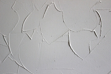 textured background of filler paste applied with putty knife in irregular dashes and strokes