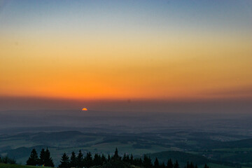 Sunset from Wasserkuppe, the highest point in Roehn Mountains under a clear sky, Germany