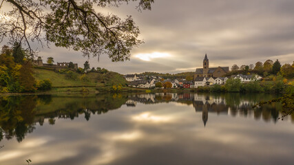 caldera lake with view at city of Ulmen in autumn at evening, Germany