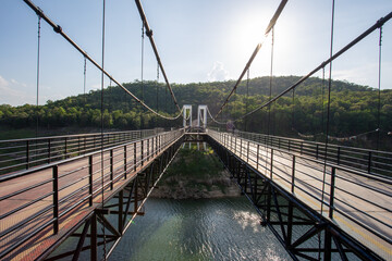 Obraz premium large suspension bridge The car can drive through it. bridge over the river Reservoirs in Thailand look grand and beautiful.