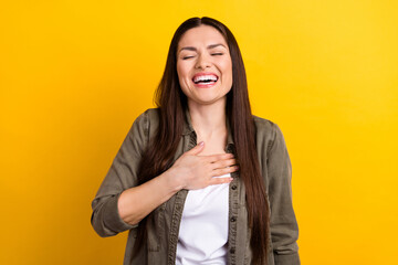 Photo of cheerful happy joyful young woman laugh good mood joke isolated on shin yellow color...